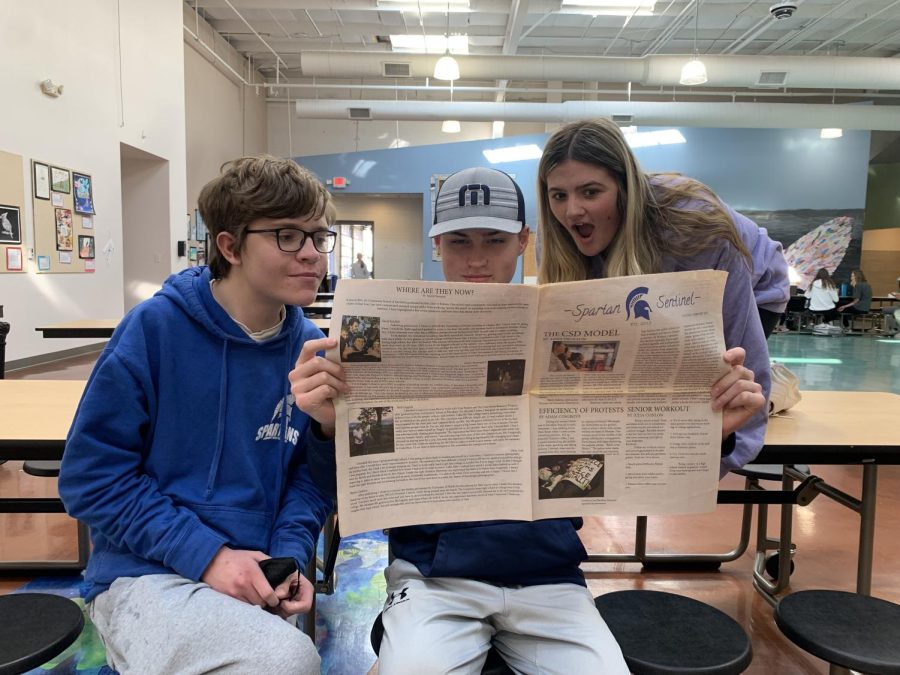 Left to right respectively: Evan Mulligan (26), Conner Shelton (25) and Emma Burch (25) read the news in the Spartan Sentinel’s one and only print newspaper.