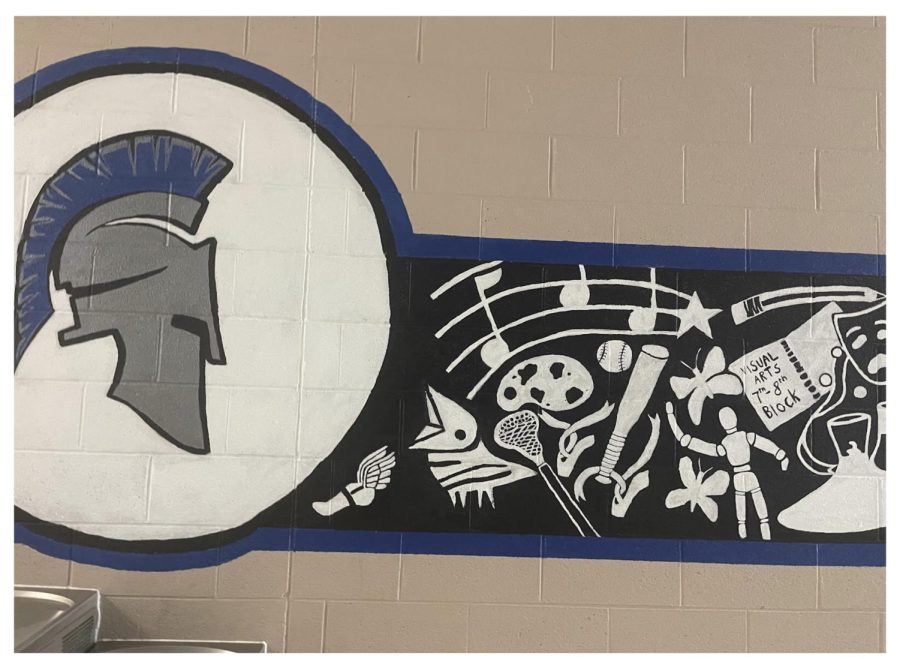 Murals cover the walls throughout a lot of the school. Outside the practice gym, the Spartan logo is connected to signs and symbols of all the activities and offerings throughout the high school. Many students pass by it on their way in and out of the building every day.
