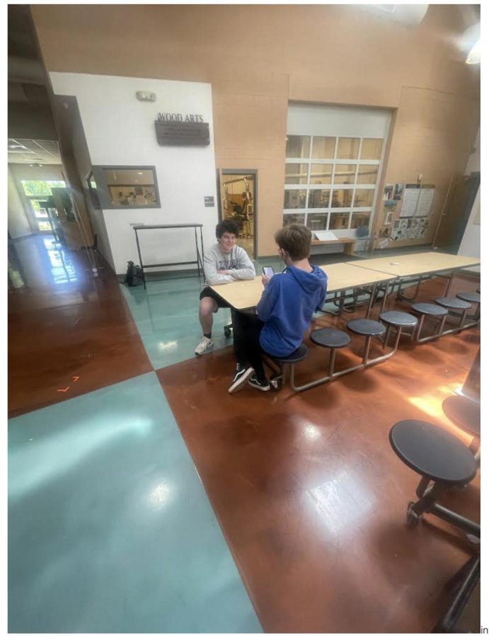 Sophomore, Evan Mulligan, interviews a classmate for a journalism story in the arts commons. Student journalist must always look for interview subjects first story, ideas, information and quotes. The arts commons is one of two main areas where students spend their learning lab free blocks.