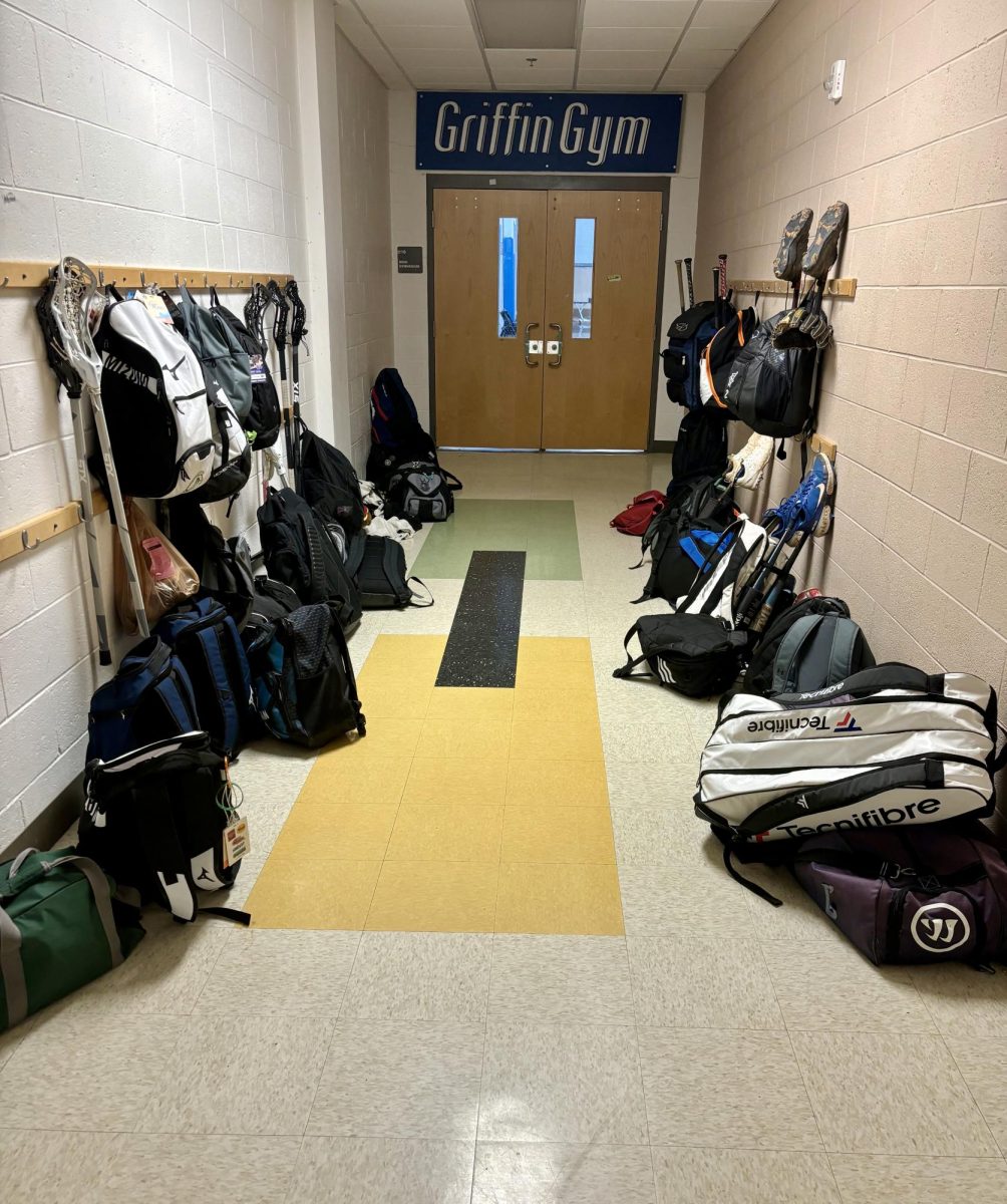 It%E2%80%99s+a+sure+sign+of+spring+when+baseball+bats%2C+cleats%2C+gloves%2C+lacrosse+sticks%2C+tennis+rackets+and+track+%26+field+bags+line+the+walls+by+the+gym+doors+each+day.