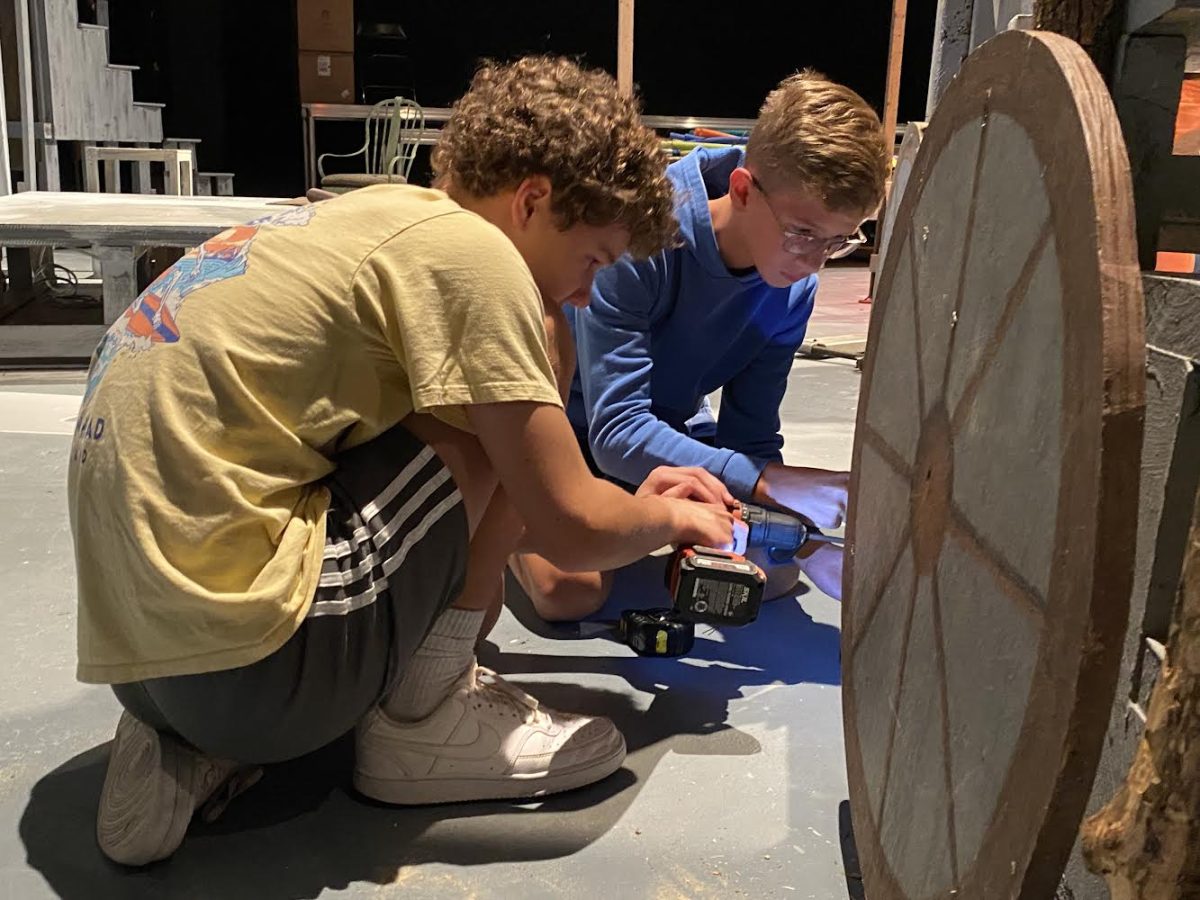 From left to right: David Colvard (‘28) and Max Thompson (‘28), two members of the Technical Theatre class, work on building a set piece for HADESTOWN.
