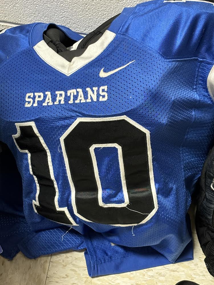 Junior, Sam Mack’s (‘26) jersey and pads sitting outside the gym mean one thing, fall sports are back. With more than 150 athletes competing across nearly a half dozen sports, fall Spartans head into battle.