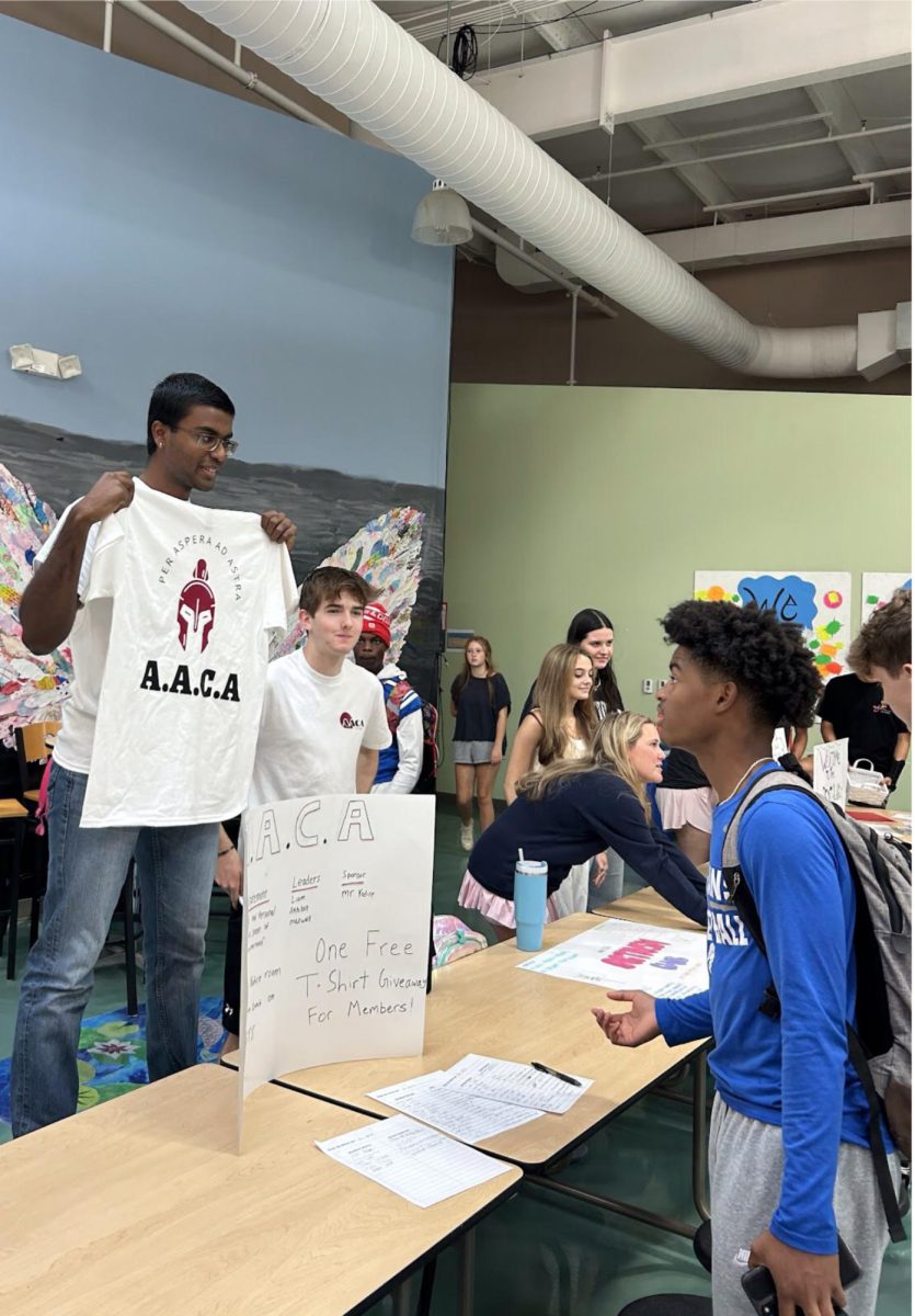 Akhilan Kumaran (‘26) shows sophomore JT Peterson (‘27) an AACA shirt and tells him about the club. The idea for this new club came after three classmates bonded in AP Government class and decided other students might benefit, too.
