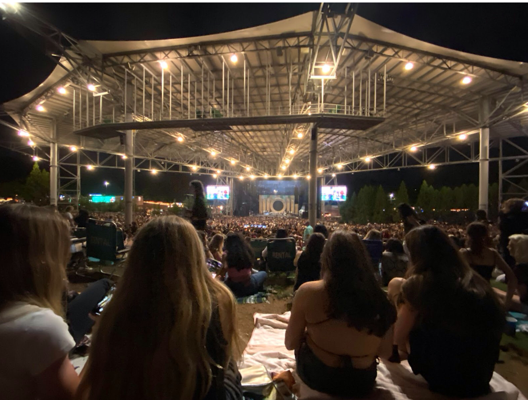 Concert venues range in size, location and layout. The Ameris Bank Amphitheatre in Alpharetta, GA (pictured), is a mid-size venue with a capacity of 12,000. However, the capacity of a smaller venue like Ovens Auditorium in Charlotte is 2,400, and the Bank of America Stadium in Charlotte, a large venue, has a capacity of about 75,000. All venue types come with their individual benefits and limitations.
