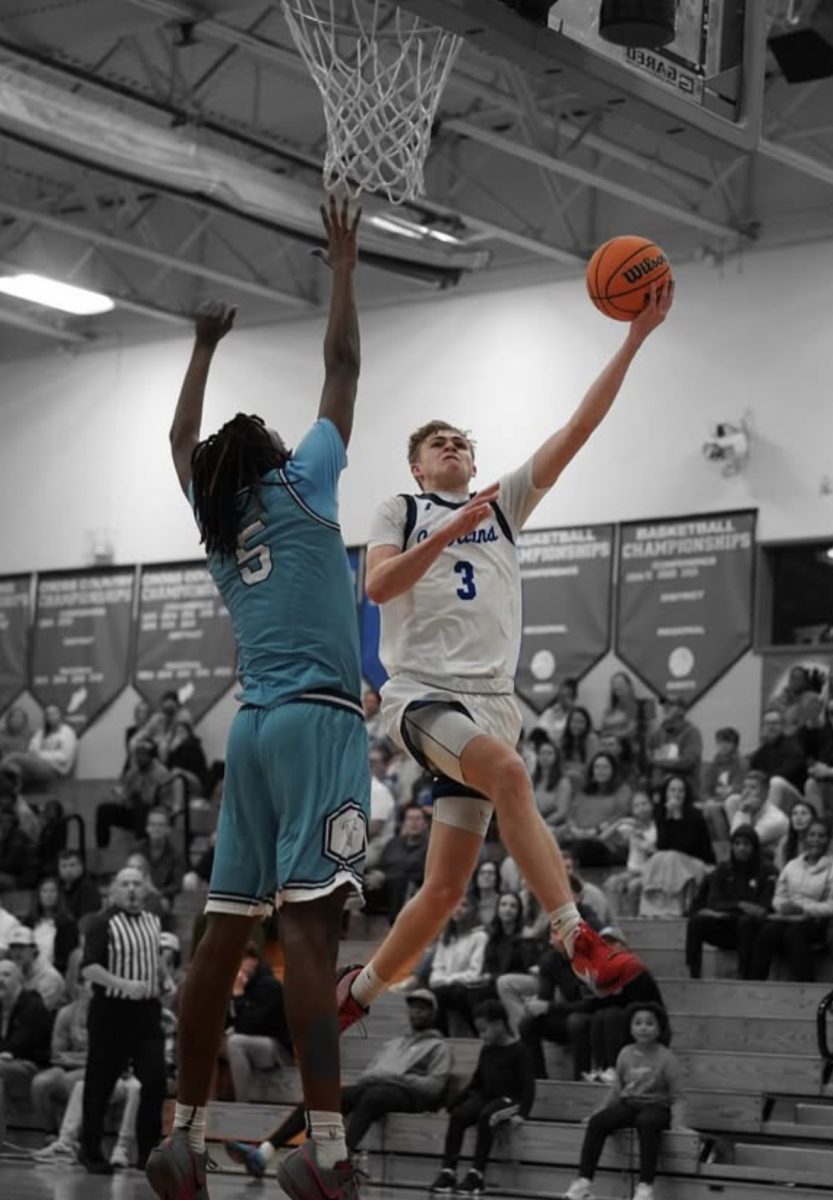 Dylan Foltz (‘25) drives to the hoop in an early season varsity game. The excitement is high for both the boys and girls basketball teams as well as for the fans who return to Griffin gym for the upcoming winter sports season. (Photo used courtesy of Mack Sidden ‘25.)