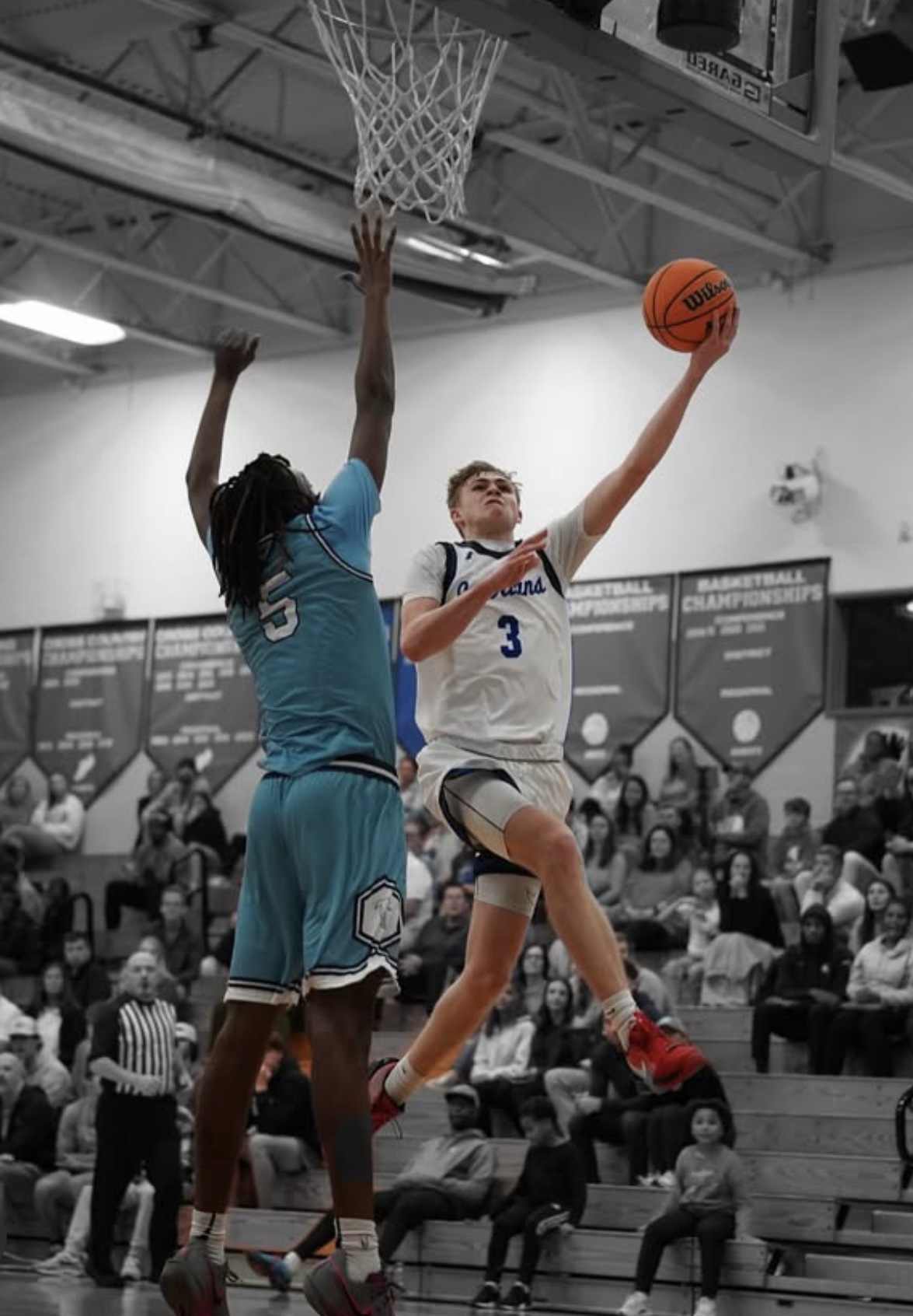 Dylan Foltz (‘25) drives to the hoop in an early season varsity game. The excitement is high for both the boys and girls basketball teams as well as for the fans who return to Griffin gym for the upcoming winter sports season. (Photo used courtesy of Mack Sidden ‘25.)