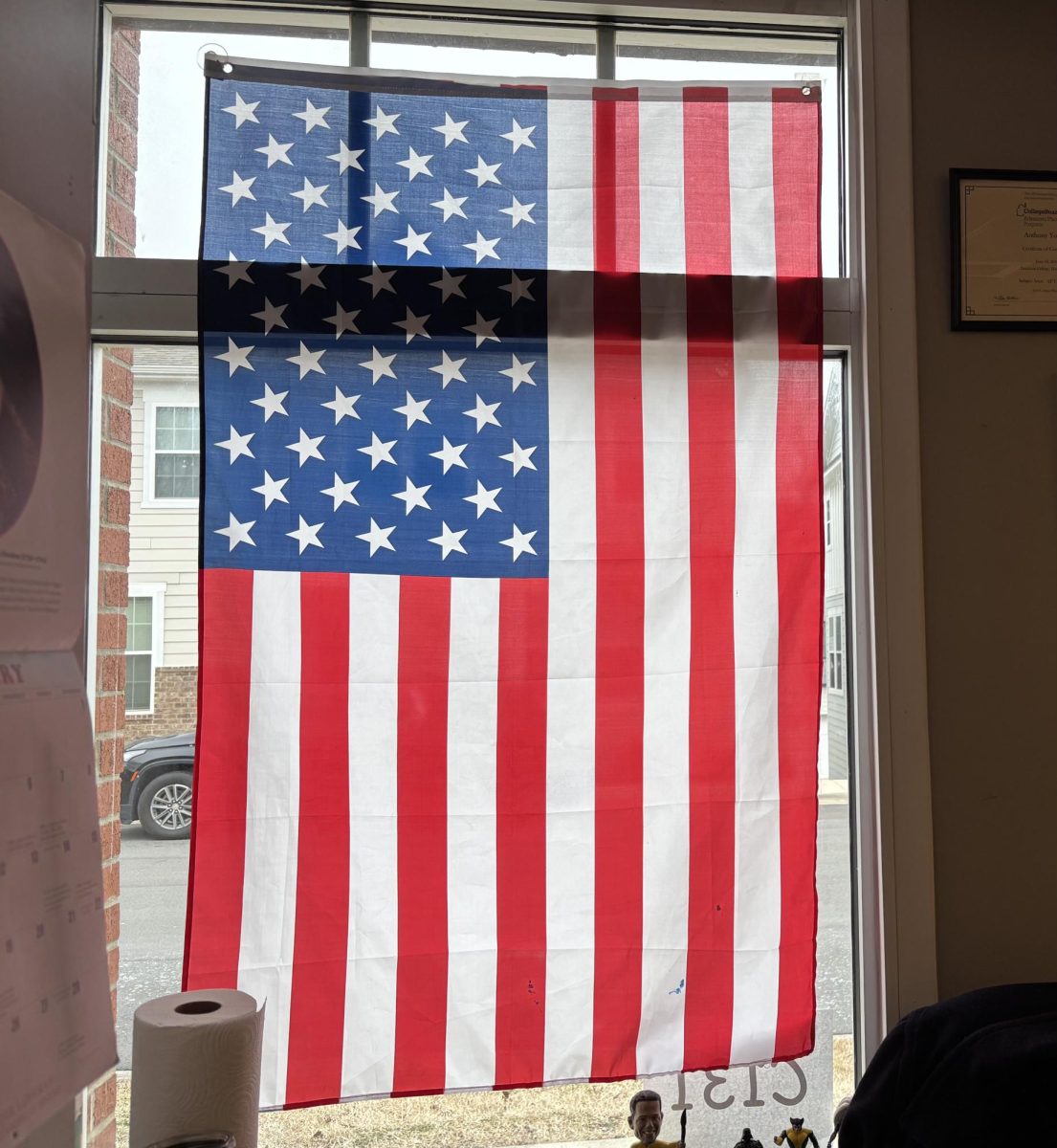 The United States flag hangs proudly in a Community School of Davidson classroom window. The flag and the anthem are staples of every sporting event and is a universally recognized symbol of our freedom. 
