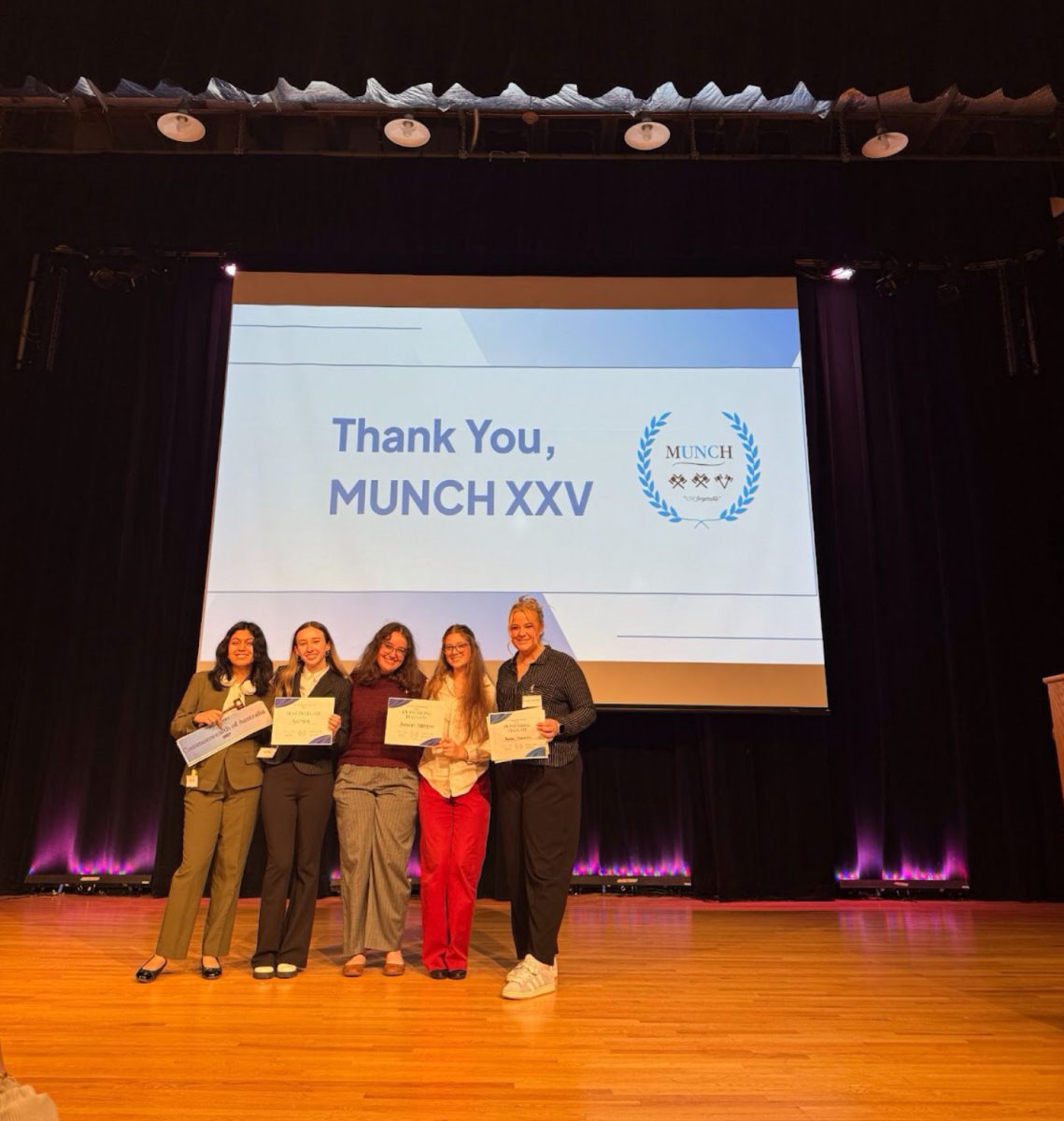 CSD students Anya Jhingran (‘26), Taylor Stevens (‘26), Anna Liz Turner (‘25), MK Michael (‘26) and Lizzie Kees (‘25) stand on the stage at UNC Chapel Hill’s Student Union building after receiving their awards. The conference consisted of more than 800 participants from varying North Carolina schools.
