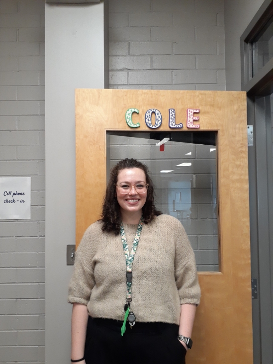 Allyson Cole stands smiling next to the iconic “Cole” letters that hang on her classroom door. Coming from Hopewell High School she is excited to begin her first year.