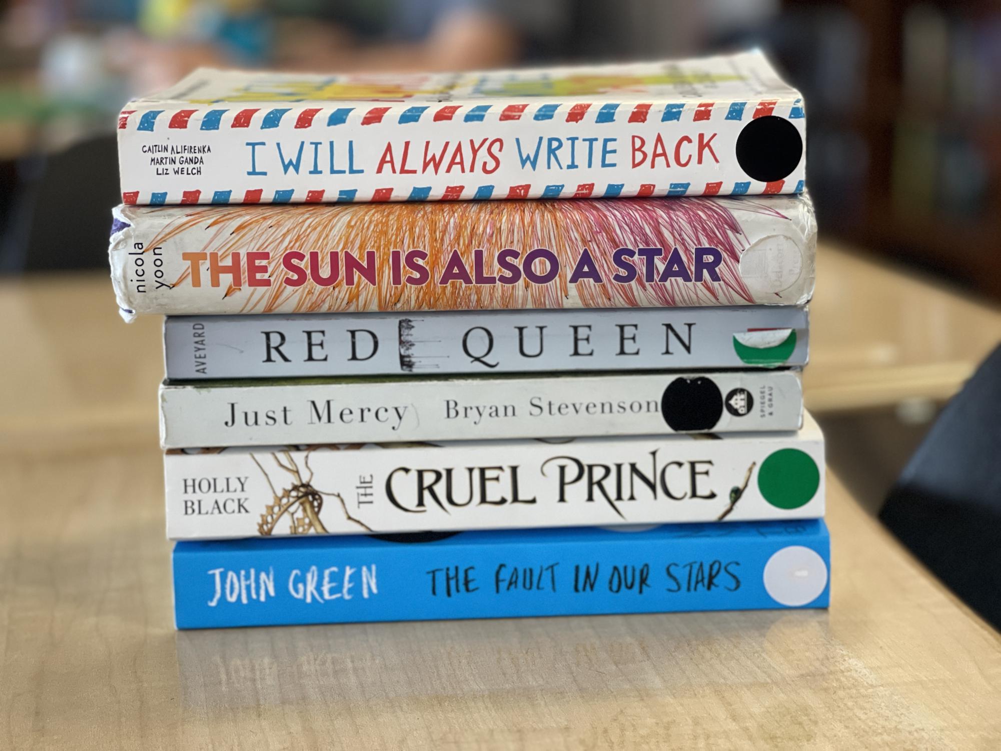 6 of the 10 recommended books sit on a classroom desk. No matter if you read them in print or electronically, reading is a way to enter another reality.
