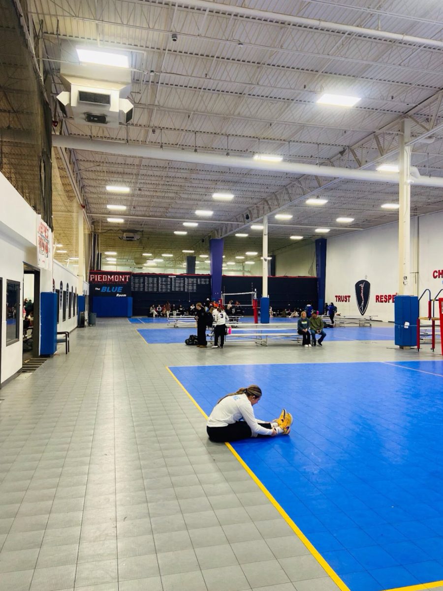 Jacee Eudy (‘26), an East Rowan High School student-athlete and member of the Rowan County volleyball club, stretches before the game. Eudy, like so many other club sport athletes, works to find a balance between her school work and having her focus on the court during the weekends.
