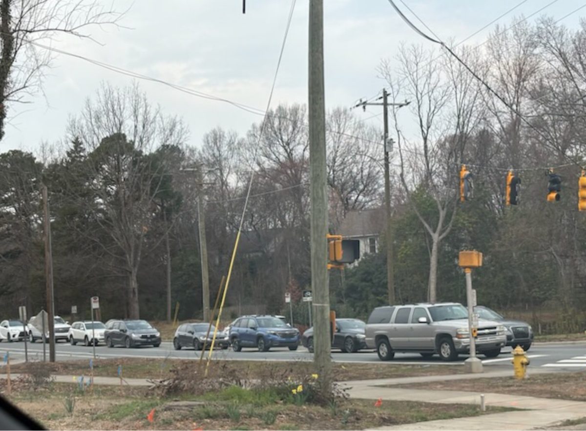 As viewed from Roosevelt Park in Davidson, a line of cars wait to proceed at the left turn signal at Griffith St right before arriving at CSD High School. Well, North Carolina construction is underway, the project faces delays and traffic continues.