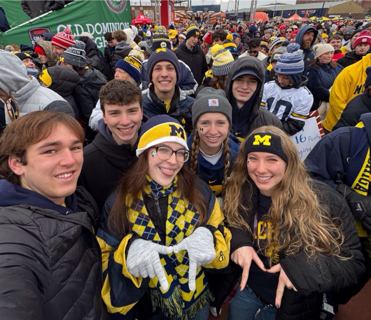 CSD alumni and University of Michigan freshman, Kate Saussele, center, is decked out in Michigan gear and surrounded by friends. Michigan has “so much school spirit!” she said. (Image courtesy of Kate Saussele.)
