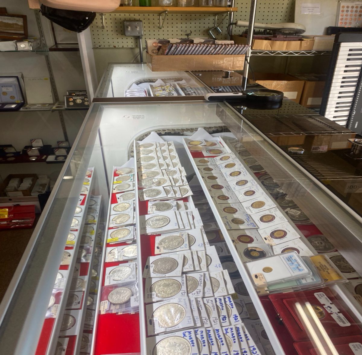 A glass case filled with antique coins of different materials, shapes, sizes, and values is just one of the many interesting displays in a pawn shop. The coins, which are from different eras and countries all over the world, caught the attention of student journalist and story writer, Liam Hogan.
